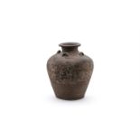 A large brown glazed storage jar