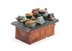 A Chinese sancai glazed pottery model of an altar table and offerings
