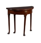 A GEORGE II MAHOGANY DEMI LUNE FOLDING TEA TABLE, CIRCA 1740