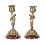 A PAIR OF FRENCH PARCEL GILT AND SILVERED FIGURAL CANDLESTICKS