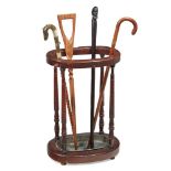 A LATE VICTORIAN WALNUT OVAL STICK STAND