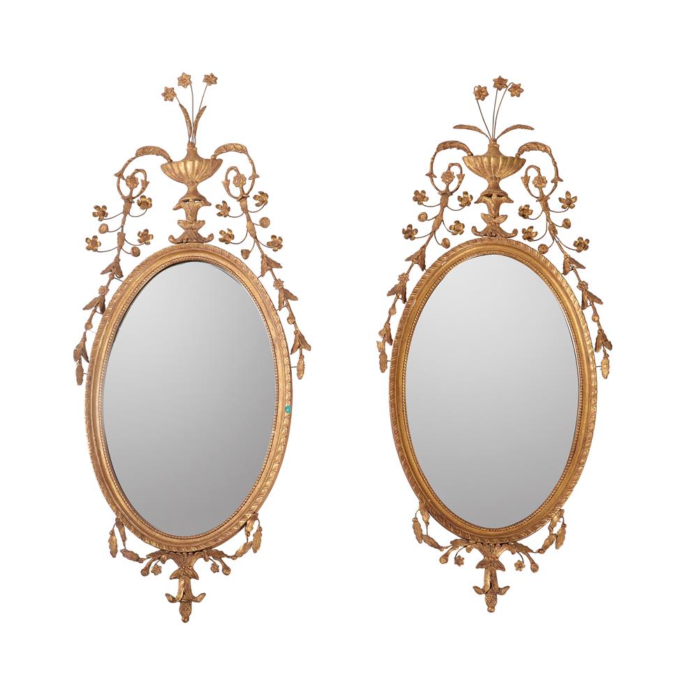 A PAIR OF GILT GESSO OVAL WALL MIRRORS