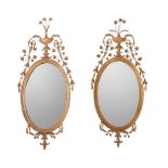 A PAIR OF GILT GESSO OVAL WALL MIRRORS