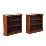 A PAIR OF WALNUT AND MARBLE BOOKCASESIN EMPIRE STYLE