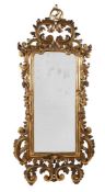 A CARVED GILTWOOD WALL MIRROR