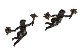 A PAIR OF PATINATED FIGURAL WALL APLIQUES