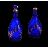 A PAIR OF BLUE GLASS DECANTERS AND STOPPERS