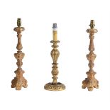 A PAIR OF CARVED GILTWOOD AND COMPOSITION CANDLESTICKS
