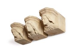 A SET OF THREE CARVED SANDSTONE CORBEL HEADS