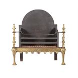 A BRASS AND CAST IRON FIRE BASKET IN BAROQUE TASTE