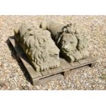 A PAIR OF STONE COMPOSITION RECUMBENT LIONS LOOSELY IN THE MANNER OF ANTONIO CANOVA