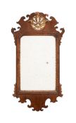 A GEORGE II WALNUT AND PARCEL GILT WALL MIRROR