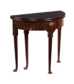 A GEORGE II MAHOGANY DEMI LUNE FOLDING TEA TABLE