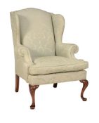 A MAHOGANY AND UPHOLSTERED WING ARMCHAIR IN GEORGE II STYLE