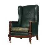 A MAHOGANY AND GREEN LEATHER UPHOLSTERED WING ARMCHAIR