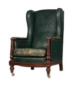 A MAHOGANY AND GREEN LEATHER UPHOLSTERED WING ARMCHAIR