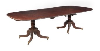 A MAHOGANY TWIN PILLAR DINING TABLE