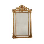 A GILTWOOD AND COMPOSITION WALL MIRROR