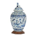 A DUTCH DELFT BLUE AND WHITE OVOID JAR AND COVER WITH LION FINIAL