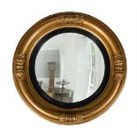 A GEORGE IV GILTWOOD AND COMPOSITION CONVEX WALL MIRROR