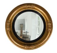 A GEORGE IV GILTWOOD AND COMPOSITION CONVEX WALL MIRROR