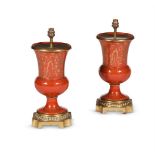 A PAIR OF RED AND GILT PORCELAIN GILT METAL MOUNTED TABLE LAMPS