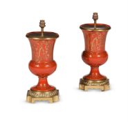 A PAIR OF RED AND GILT PORCELAIN GILT METAL MOUNTED TABLE LAMPS