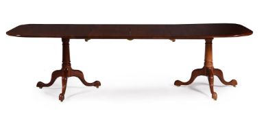 A MAHOGANY TWIN PILLAR DINING TABLE IN GEORGE III STYLE