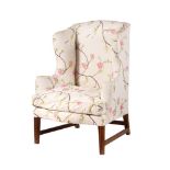 A MAHOGANY AND UPHOLSTERED WING ARMCHAIR IN GEORGE III STYLE
