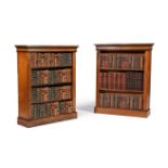 A MATCHED PAIR OF OAK AND EBONISED OPEN BOOKCASES