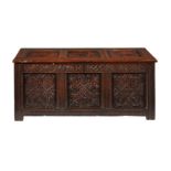 A CHARLES II CARVED OAK CHEST