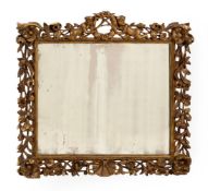 A CARVED GILTWOOD WALL MIRROR