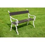A WHITE PAINTED CAST IRON AND WOOD GARDEN SEAT