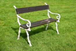 A WHITE PAINTED CAST IRON AND WOOD GARDEN SEAT