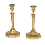 A PAIR OF CONTINENTAL GILT METAL CANDLESTICKS