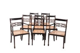 A SET OF EIGHT EBONISED AND PARCEL RED PAINTED DINING CHAIRS IN REGENCY STYLE