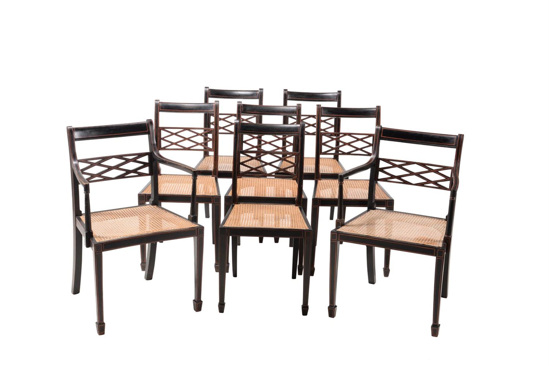 A SET OF EIGHT EBONISED AND PARCEL RED PAINTED DINING CHAIRS IN REGENCY STYLE