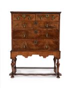 A GEORGE II WALNUT CHEST ON STAND