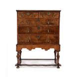 A GEORGE II WALNUT CHEST ON STAND