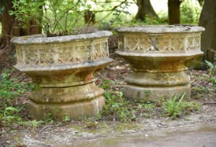 A PAIR OF STONE COMPOSITION GARDEN PLANTERS, IN GOTHIC TASTE