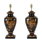 A PAIR OF BLACK AND GILT DECORATED POTTERY TABLE LAMPS IN REGENCY TASTE