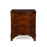 A WALNUT AND CROSSBANDED SERPENTINE FRONTED CHEST OF DRAWERS IN 18TH CENTURY STYLE