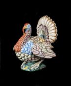 A FAIENCE MODEL OF A TURKEY COCK IN THE STYLE OF PAUL HANNONG, STRASBURG