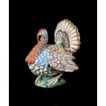 A FAIENCE MODEL OF A TURKEY COCK IN THE STYLE OF PAUL HANNONG, STRASBURG