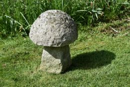 A CARVED STONE STADDLE STONE OR GARDEN MODEL OF A MUSHROOM