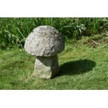 A CARVED STONE STADDLE STONE OR GARDEN MODEL OF A MUSHROOM