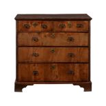 A WALNUT CHEST OF DRAWERS