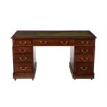 A MAHOGANY TWIN PEDESTAL DESK IN GEORGE III STYLE