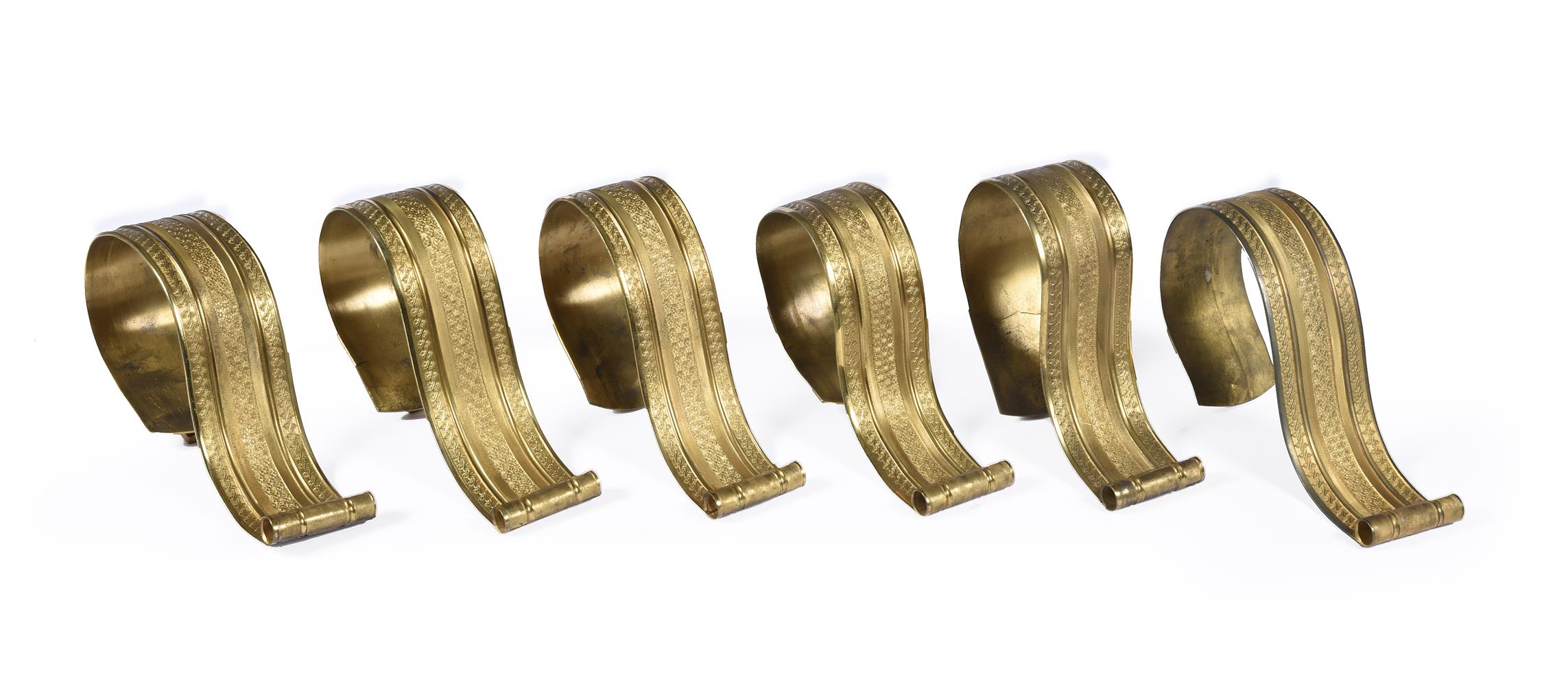 A SET OF SIX GILT BRASS CURTAIN TIE-BACKS