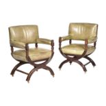 A PAIR OF WALNUT AND LEATHER UPHOLSTERED LIBRARY ARMCHAIRS